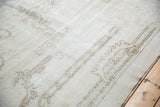 Distressed vintage Sparta carpet with faded scrolling rococo style patterns and even wear.