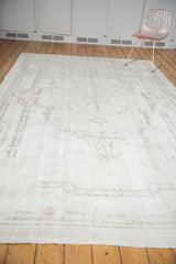 Secured end of distressed Sparta carpet with even wear, faint foundation, and beige rococo patterns.