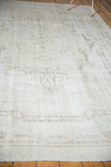 Faint ivory and coffee brown rococo patterns with even wear on a distressed Sparta carpet.