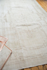 Distressed vintage Sparta carpet with worn pile and subtle ivory rococo style patterns.