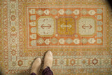 Distressed Northwest Persian rug featuring low pile, central medallions, and Laleh Abassi border.