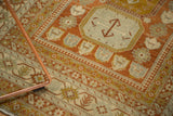 Distressed Northwest Persian rug corner: Laleh Abassi border and floral field, burnt orange, powder blue.