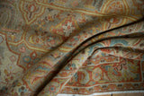 Textured pile of a distressed vintage Armenian rug showing European design details.