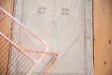 Distressed vintage Oushak rug's geometric border and tribal stair-step pattern detail.