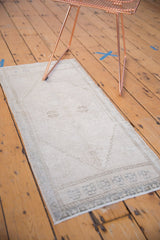 Vintage distressed Oushak rug corner with aged ivory and oxidized silver geometric border.
