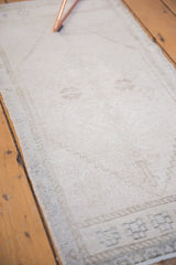 Distressed vintage Oushak rug with even wear, featuring ivory and platinum tones.