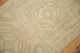 Distressed vintage Oushak rug detail: low pile, muted sea foam green, ivory finned comb pattern.