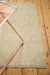Faded geometric patterns and low pile texture on a distressed vintage Turkish Oushak rug.