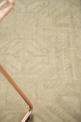 Softly distressed ivory and sea foam green Oushak rug texture.