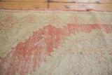 Distressed Oushak rug runner texture: abrash, faded cinnabar, and exposed foundation.