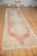 Distressed Oushak runner, an end finial on its antique ivory field with faded cinnabar.