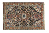 Vintage Sarouk rug with central medallion, dense floral field, rich dark and warm tones, 3'5