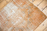 Distressed Oushak rug runner close-up; tone-on-tone texture of pale copper and antique ivory.