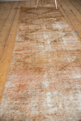 Vintage Oushak runner's distressed texture showing pale copper and antique ivory wear.