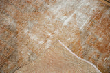 Distressed vintage Oushak runner's copper and ivory pile and hand-knotted foundation.