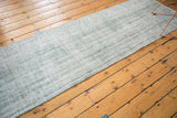 Long vintage Oushak runner with distressed low shorn pile in muted sea foam green.
