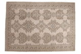 Distressed Oushak carpet, allover densely ornamented floral pattern in sand beige, coffee brown, slate gray.