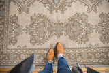 Vintage Oushak low pile texture with ornamented floral motifs in sand beige and brown.