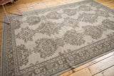Distressed Oushak carpet, low pile allover floral pattern in sand beige, coffee brown, and slate gray.