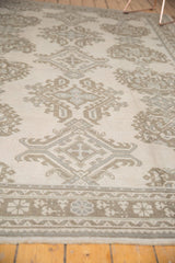 Vintage Distressed Oushak border with softened geometric and floral patterns in sand, coffee, slate.
