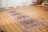 Antique Persian Malayer runner, dusty blush field, indigo medallions, and lovebird motifs.