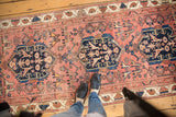 Antique Malayer runner: Indigo blue medallion, lovebird motifs on dusty rose field with even wear.