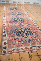 Antique Malayer rug corner detail, revealing indigo blue ram's horn contour, lovebird motifs, and aged ivory border.