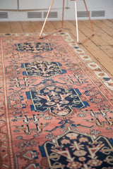 Antique Malayer runner's dusty blush and indigo geometric pattern with rams horn contours.
