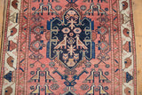 Antique Malayer rug detail: hand-knotted lovebird motifs, indigo rams horn medallion, dusty blush.