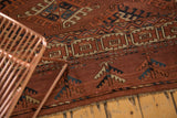 Antique Turkmen carpet end, featuring low pile, secured fringe, and chestnut, blue, beige motifs.
