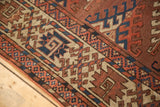 Antique Turkmen rug's border with intricate geometric patterns in chestnut, navy, and beige.