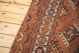 Antique Turkmen carpet border detail with low pile, geometric guls in chestnut brown and navy blue.