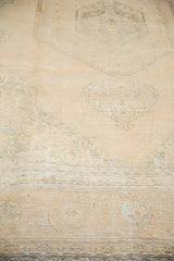 Pale melon and ivory geometric motifs with distressed pile on vintage Sivas carpet.