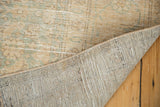 Distressed pale melon and seafoam pile of the Sivas carpet with its hand knotted foundation.