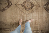 Vintage distressed Khorassan rug, charcoal brown medallion, serrated contour, and soft pile wear.