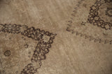 Sharp serrated medallion contour and intricate charcoal brown design of the distressed Khorassan rug.