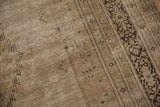 Intricate charcoal brown border and distressed antique ivory field, vintage Khorassan rug texture.