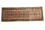 Antique Serab runner with triple geometric medallions on a worn camel field.