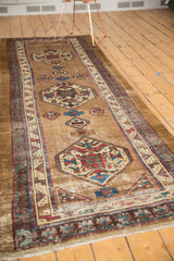 Antique Serab runner: tribal geometric medallion in camel, sky blue, aubergine, with storied wear.