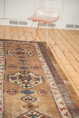 Geometric medallion and natural camel field of the antique Serab runner, showing some etching.