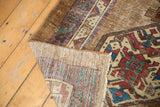 Antique Serab runner's hand knotted foundation, secured side, and worn geometric pile.