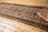 Antique Serab runner's geometric medallion with natural camel, red, blue tones, and field wear.