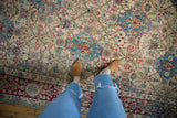 Distressed Kerman carpet's low pile, ivory, sky blue, and fuchsia floral lattice.
