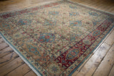 Distressed Kerman rug's low pile and faded red border detail with sky blue.