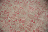 Vintage Oushak carpet's distressed pile shows mostly even wear with raspberry florals on platinum.