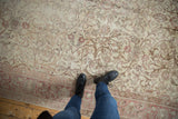 Distressed Sivas carpet in ivory, blush, and bronze with allover scrolling floral vinery.