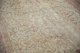 Distressed Sivas carpet showcasing subtle ivory field, blush floral and scrolling vinery.
