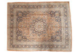 Vintage Persian Meshed carpet with roundel medallion, pale rust field, and navy floral vinery.