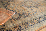 Detailed border of vintage Meshed carpet showing navy blue, rust, and sky blue palmettes.