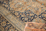 Vintage Meshed carpet's outer stripe border adjacent to the navy field with intricate vinery.
